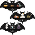 Three black wooden bat-shaped shelves with celestial and eye designs, each displaying decorative items.