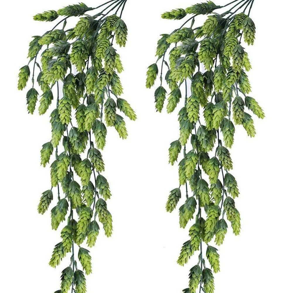 Two artificial hops vines with green cones hanging against a white background, showing multiple branches and detailed foliage.