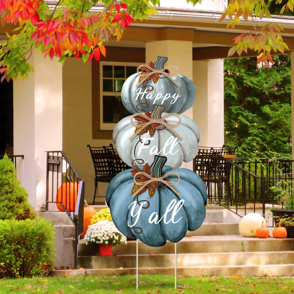 Stackable blue pumpkin yard stake with Happy Fall Y'all text, displayed on a porch during autumn.