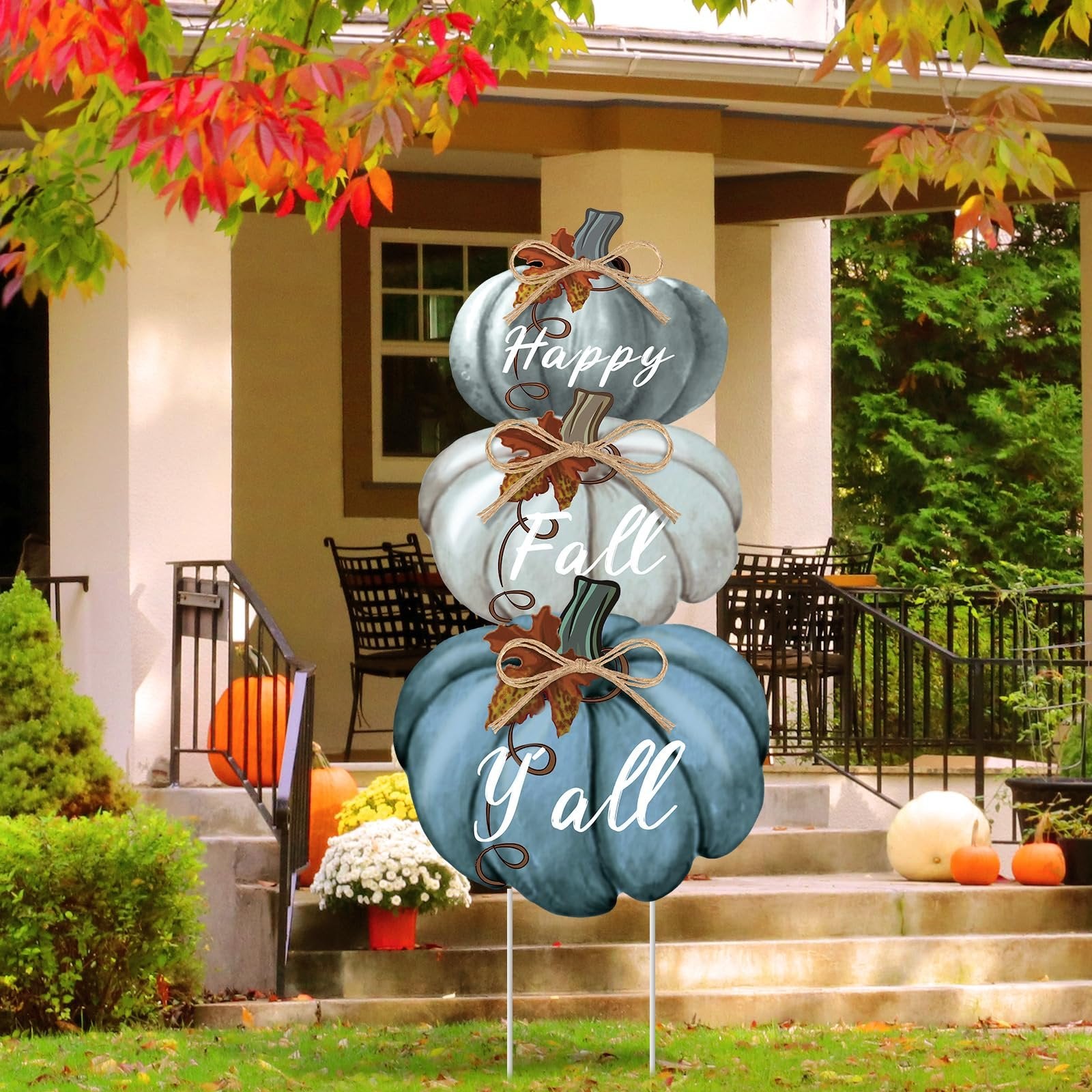 Stackable blue pumpkin yard stake with Happy Fall Y'all text, displayed on a porch during autumn.