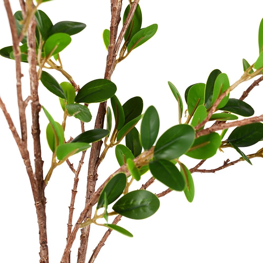 Close-up of artificial eucalyptus branches with green plastic leaves against a white background.