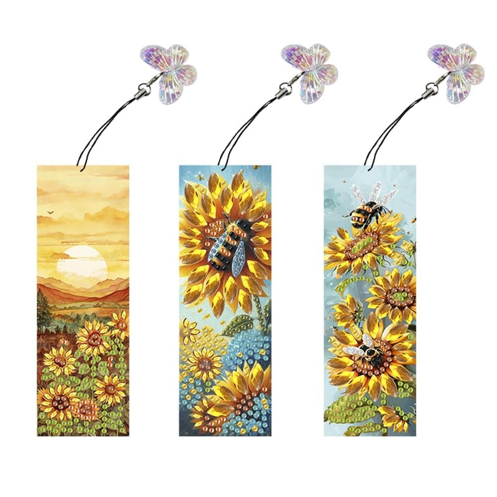 Three diamond painting bookmarks with sunflower and bee designs, each with a butterfly pendant.
