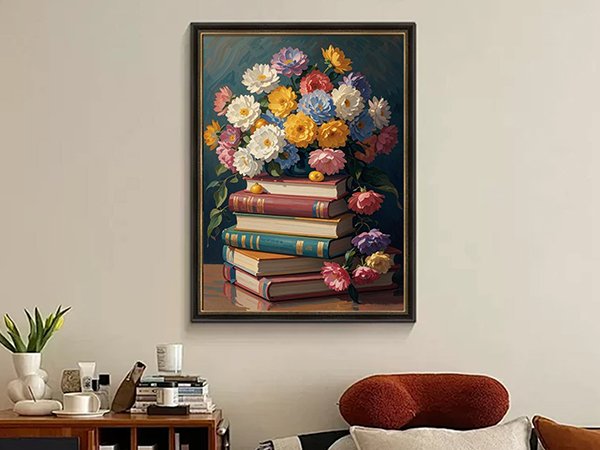 Diamond art painting of a stack of books with colorful flowers on top, framed and hanging on a wall.