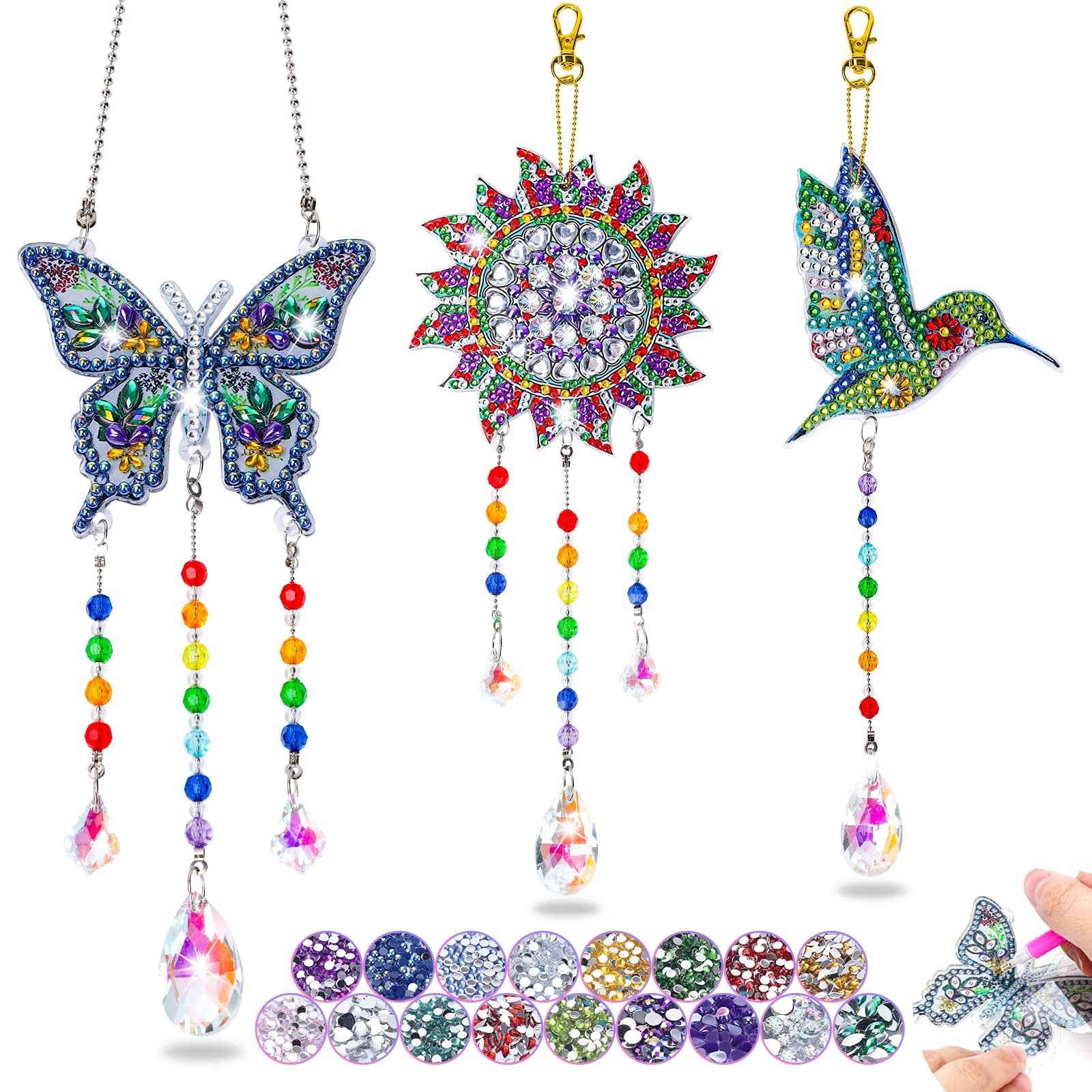 Diamond painting suncatcher kit with butterfly, sun, and hummingbird designs, plus crystal pendants and beads.