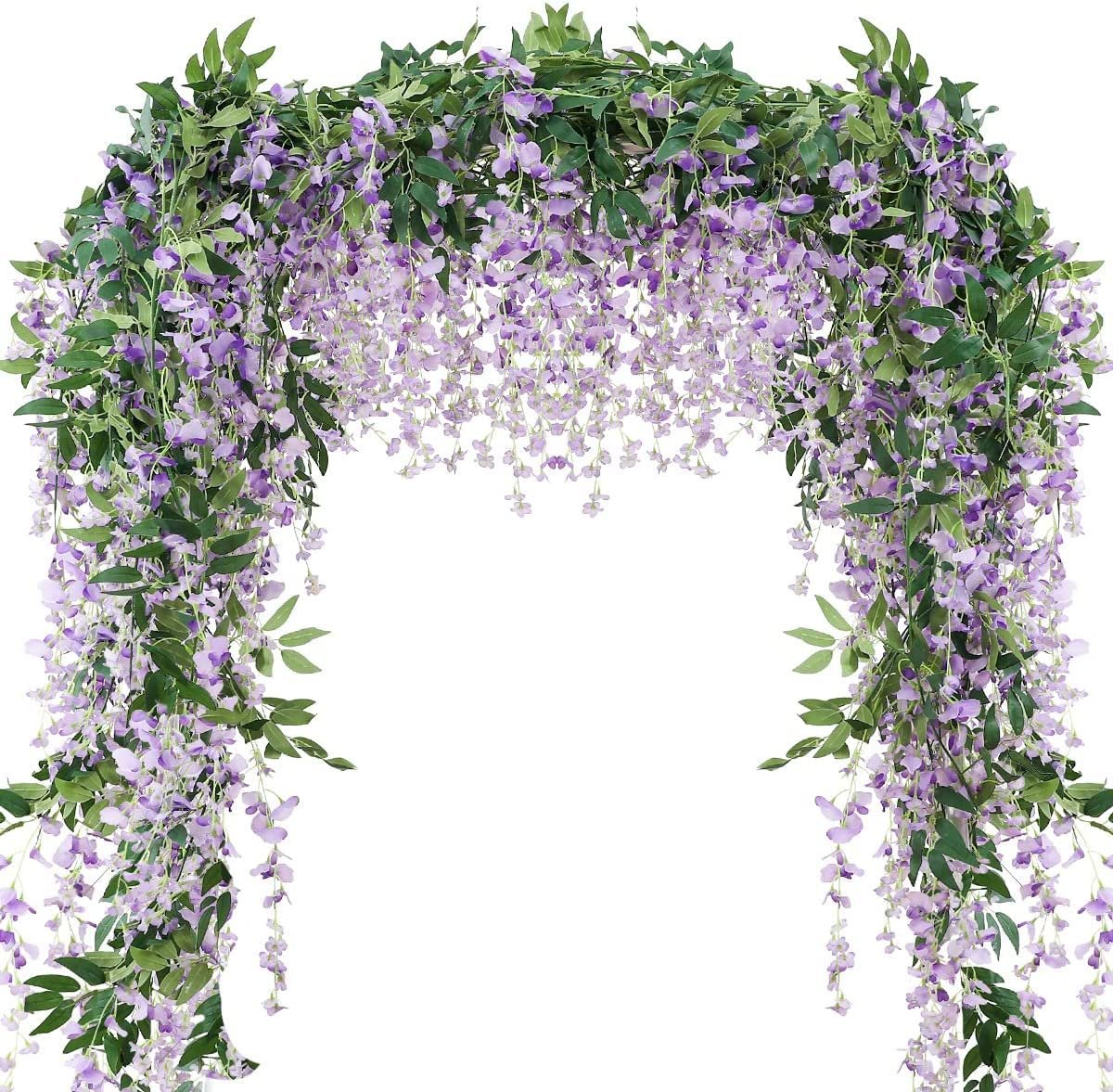 Artificial purple wisteria garland draped over an archway, featuring cascading faux flowers and green leaves.