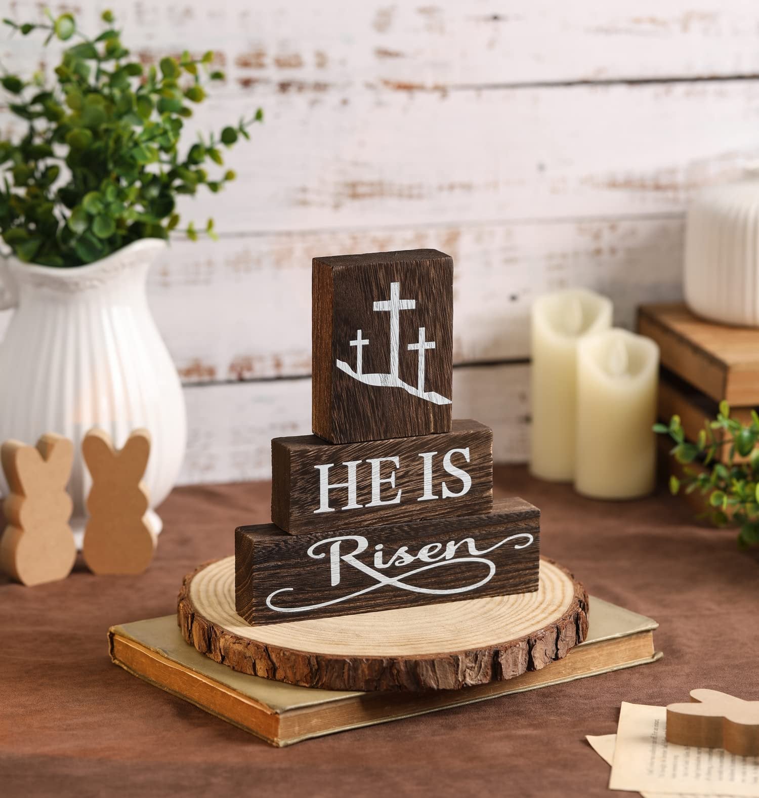 Three stacked wooden blocks with white text and crosses, part of a rustic Easter tabletop centerpiece.