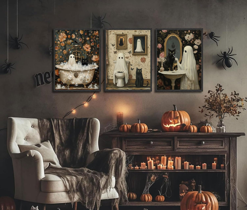 Three Halloween-themed canvas art prints depicting ghosts and black cats in retro bathroom scenes, displayed in a decorated room.