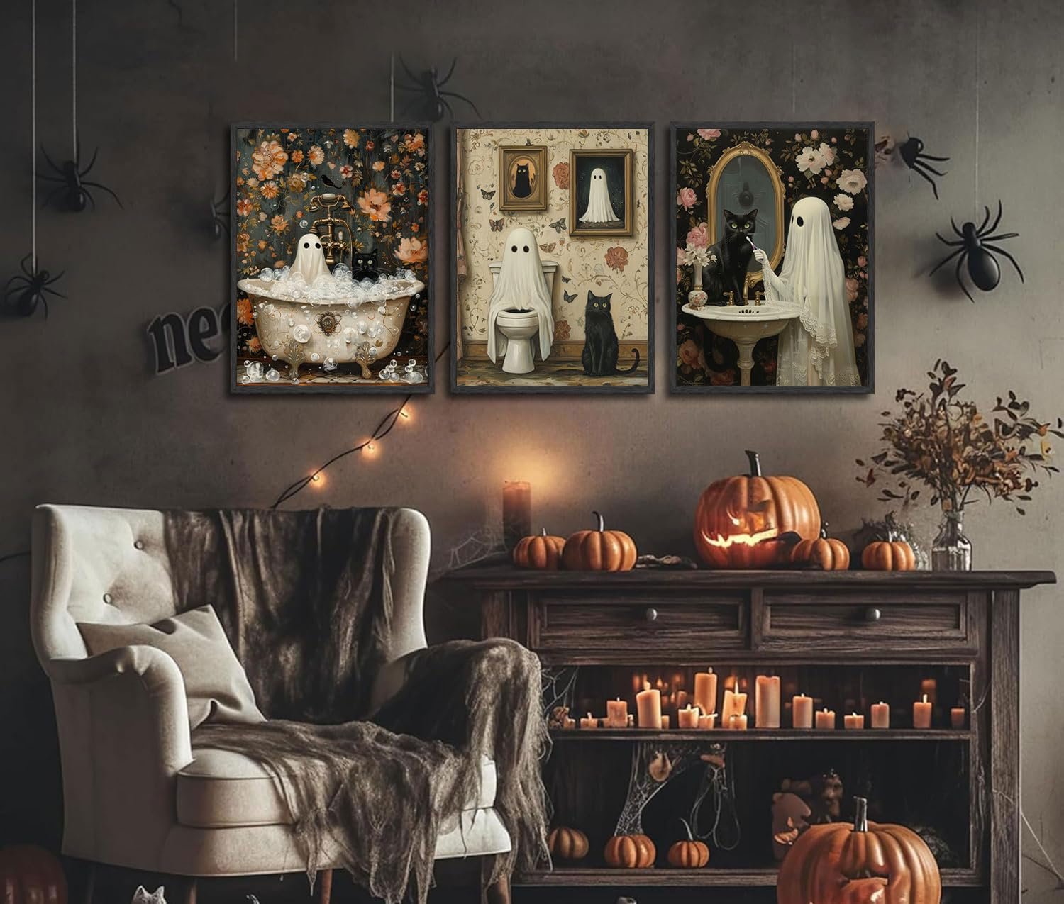 Three Halloween-themed canvas art prints depicting ghosts and black cats in retro bathroom scenes, displayed in a decorated room.
