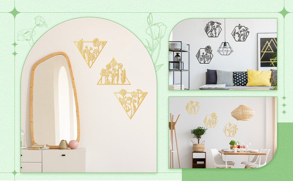Three gold metal floral wall art pieces in triangle frames displayed on a white wall next to a mirror.