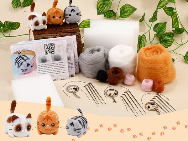 Needle felting starter kit with wool, needles, foam pads, keychains, and finished cat figures.