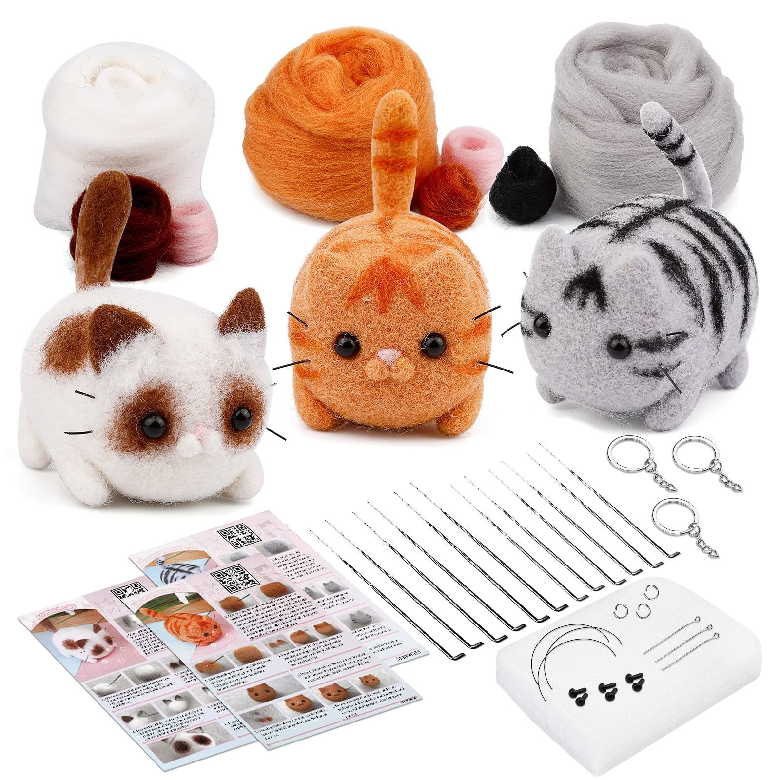 Needle felting kit with three finished cat figures, wool roving, felting needles, foam pad, keychains, and instruction cards.