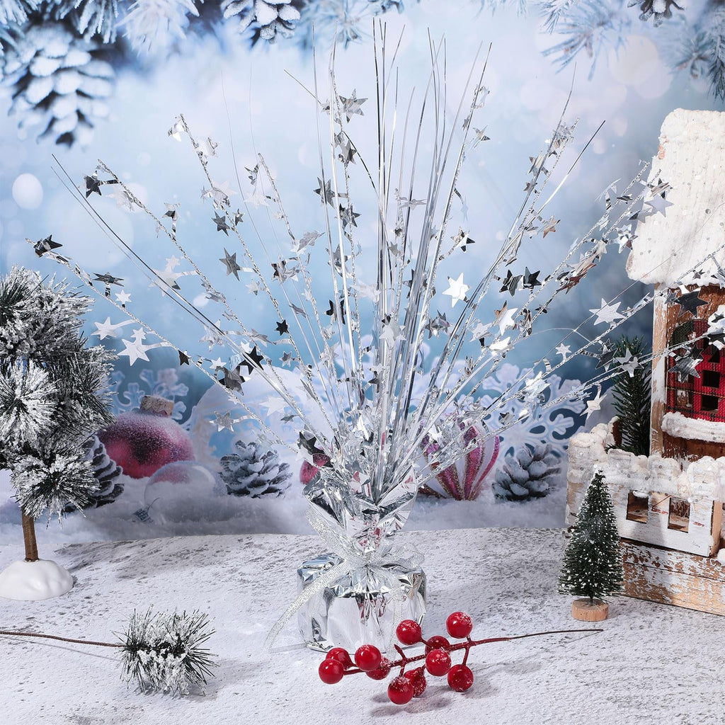 Silver metallic foil spray star burst table centerpiece with a snowy winter background and decorative elements.