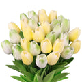 Bouquet of artificial yellow and green tulips with green leaves, isolated on white background.