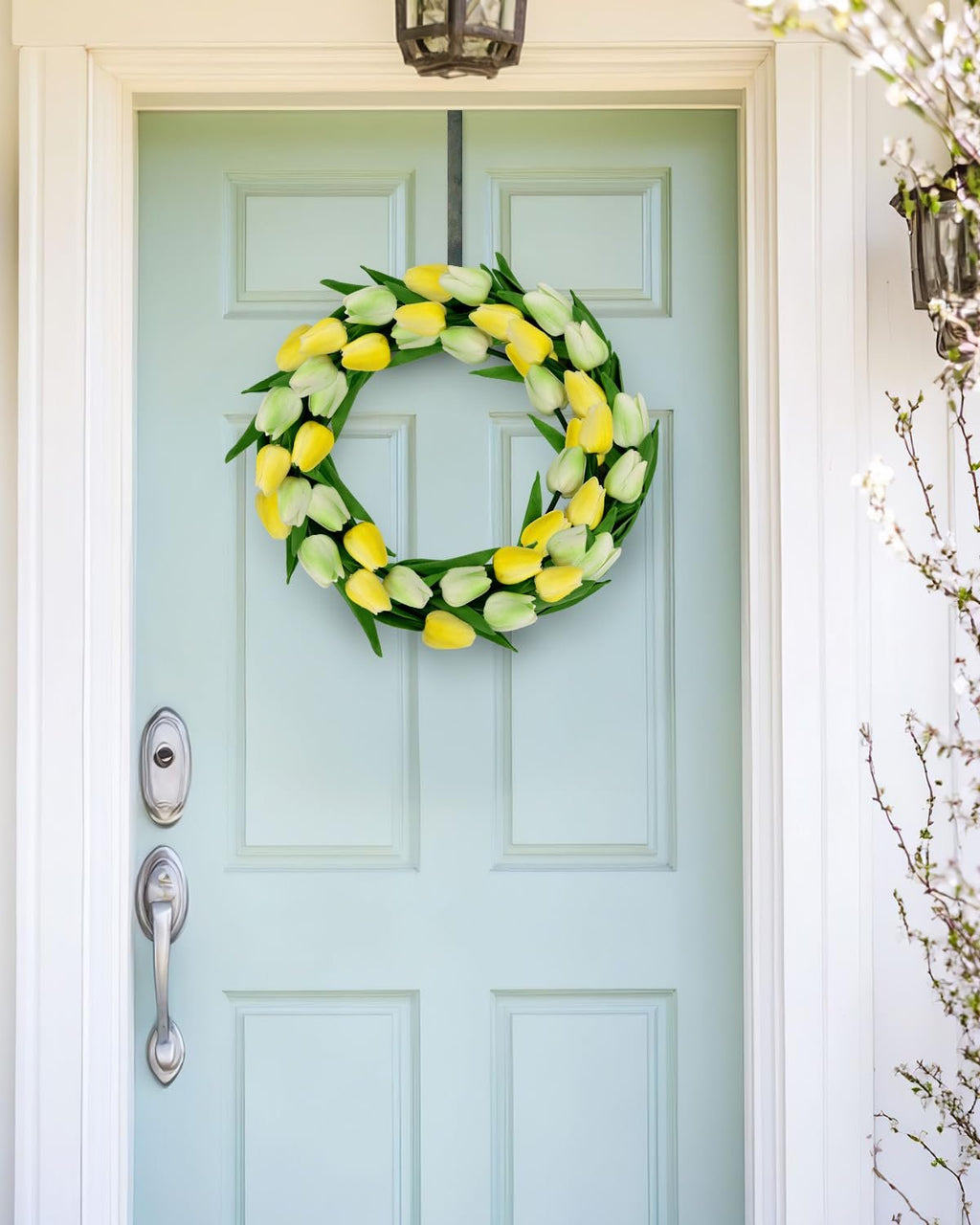 Front door decorated with a yellow and white tulip wreath