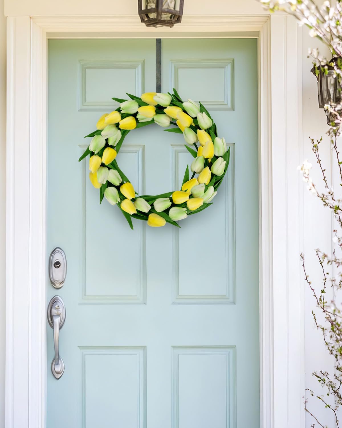 Front door decorated with a yellow and white tulip wreath