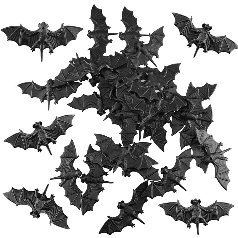 A collection of 30 small black 3D plastic bat decorations scattered against a white background.