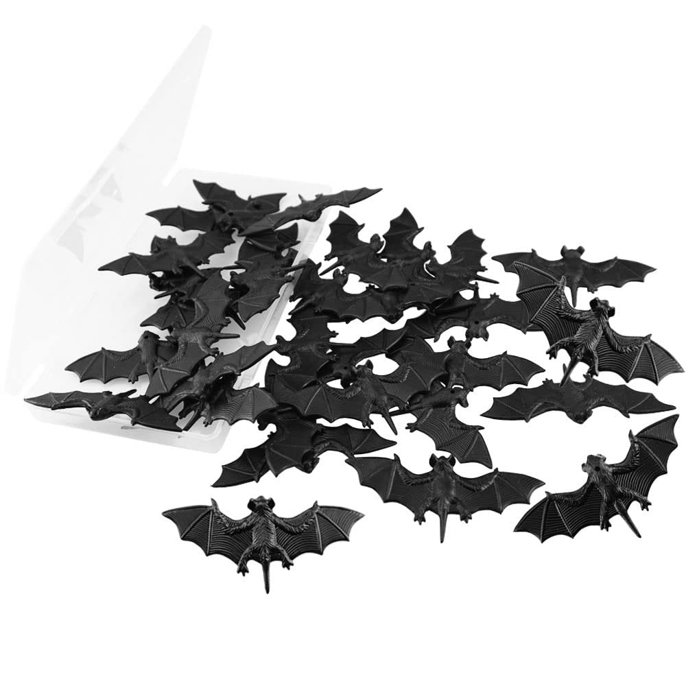 A pile of 30 small black 3D plastic bat decorations spilling from a clear container.