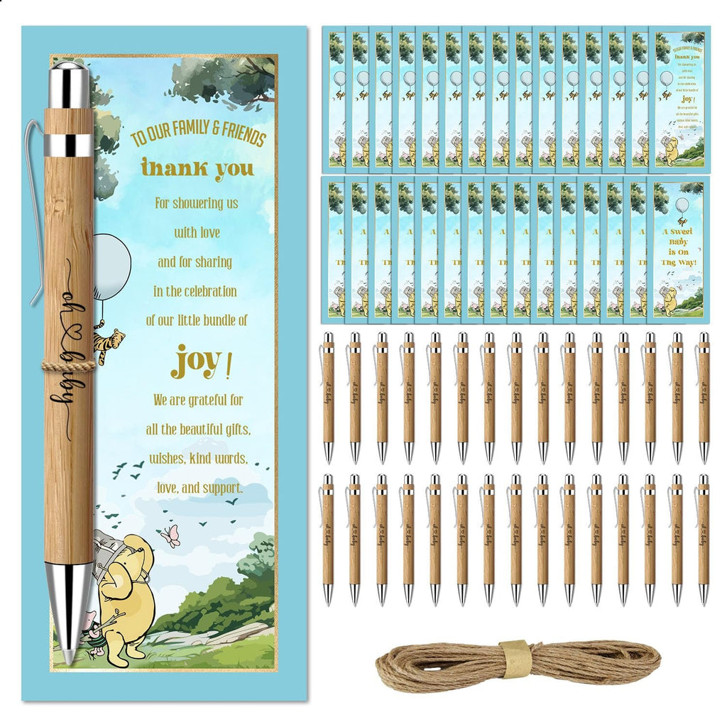 Baby shower favor set with bamboo pens, greeting cards, and twine on a white background. One pen is shown close-up with text.