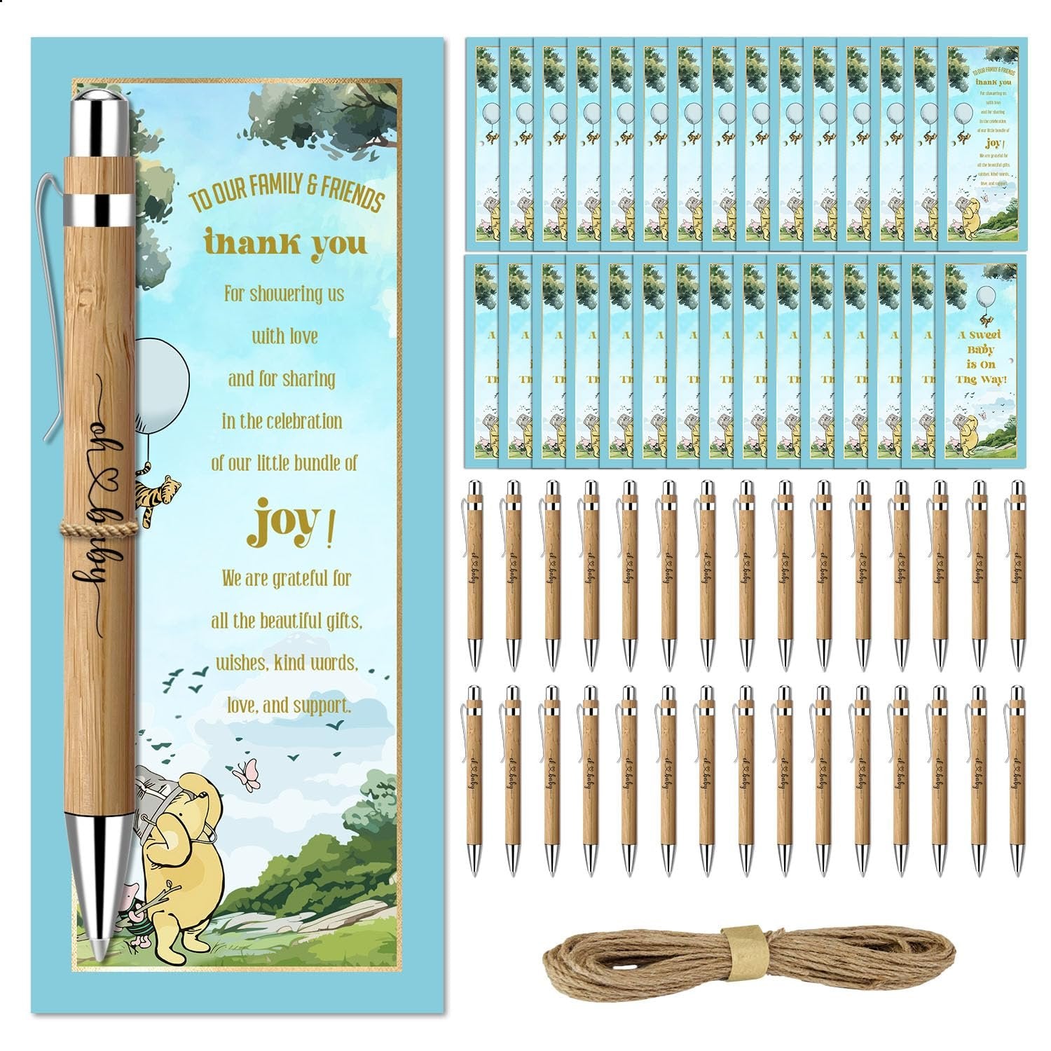 Baby shower favor set with bamboo pens, greeting cards, and twine on a white background. One pen is shown close-up with text.