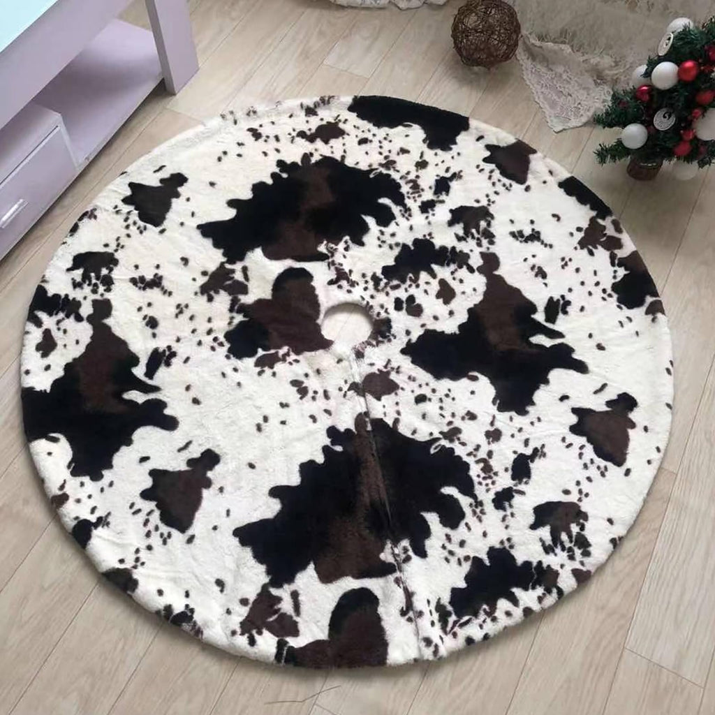 Round faux fur Christmas tree skirt with cow print pattern on a wooden floor.