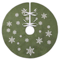 Green burlap Christmas tree skirt with white snowflake print and white trim, tied with white ribbons.