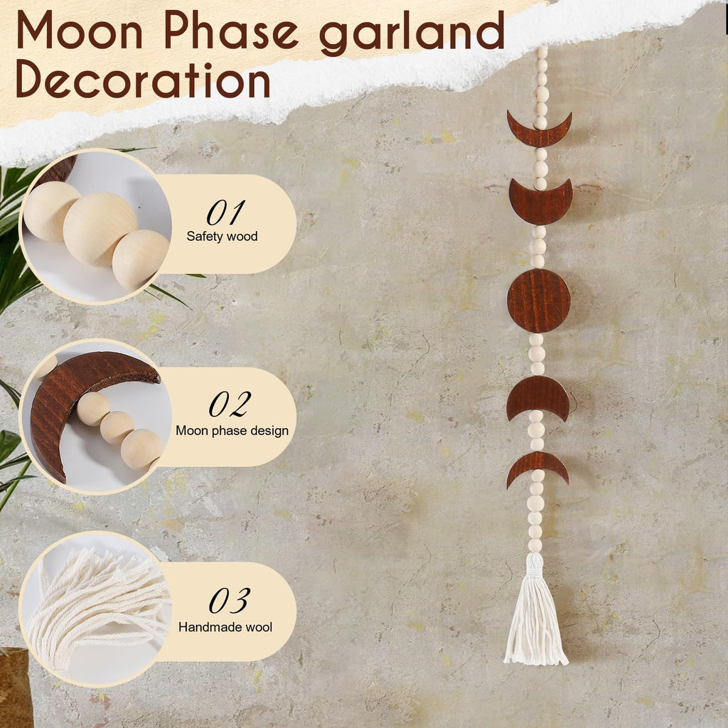Moon phase garland decoration with wooden moons, beads, and tassel hanging on a textured wall.