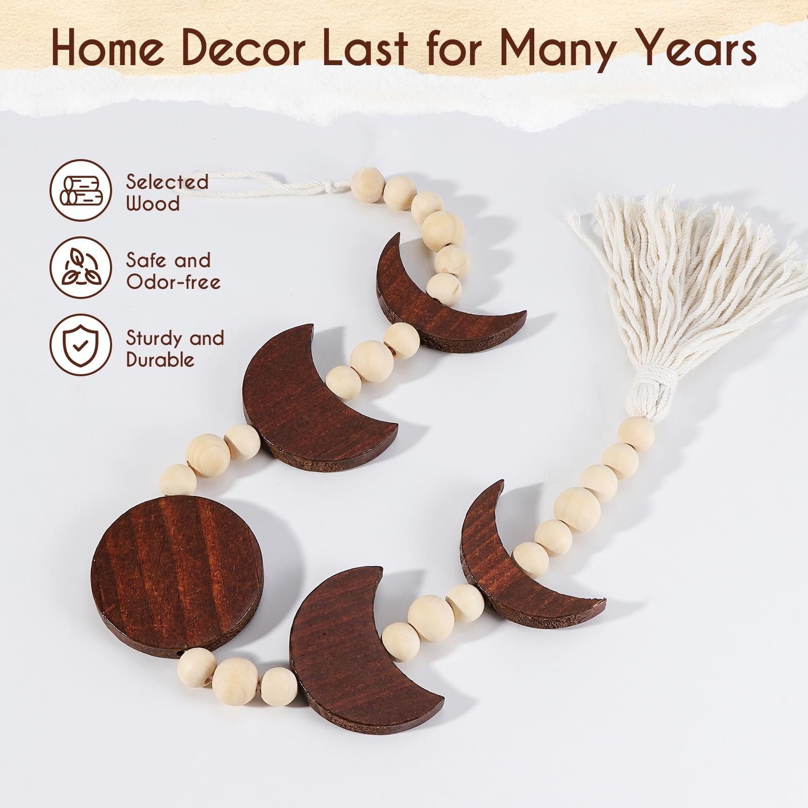 Wooden moon phase wall hanging with beads and tassel on a white background.