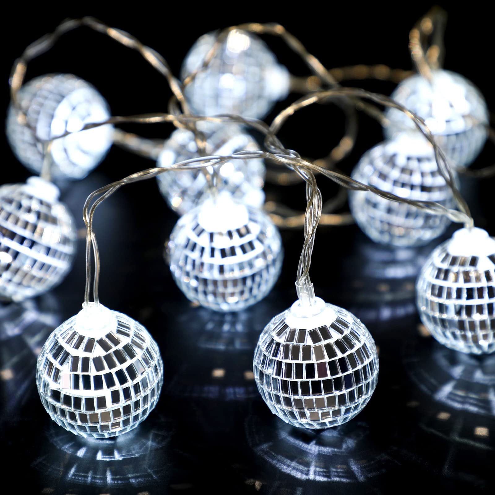 String lights with 30 small mirrored disco balls on a black reflective surface