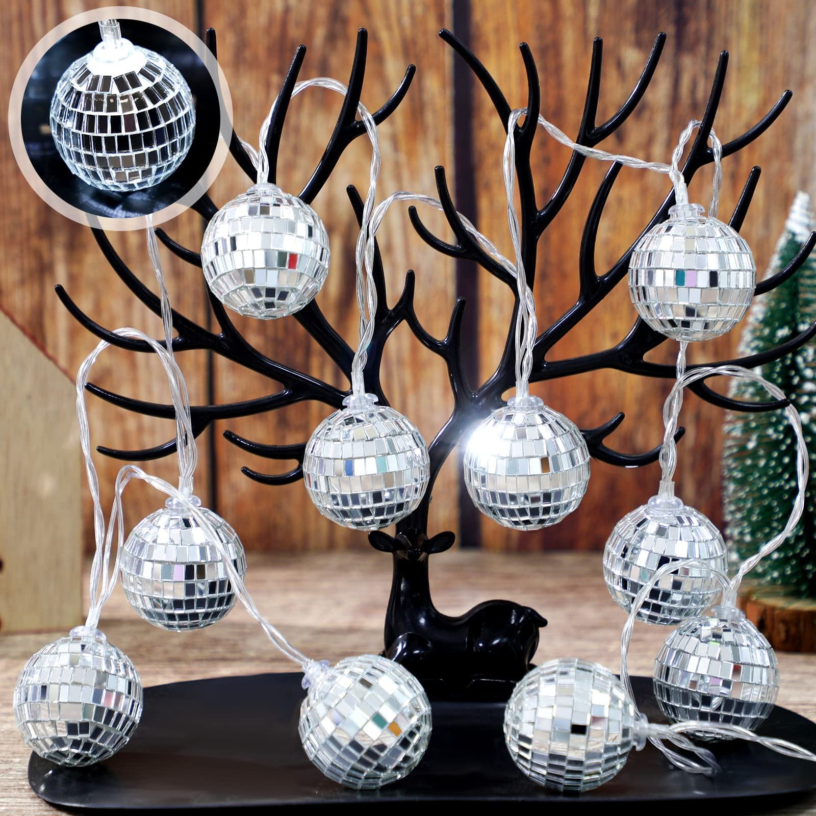 String of 30 silver mirror ball LED lights displayed on a black deer figurine against a wooden background.