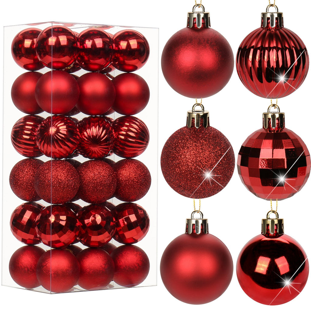 Set of red shatterproof Christmas ball ornaments in a clear box and displayed individually, featuring various textures and finishes.
