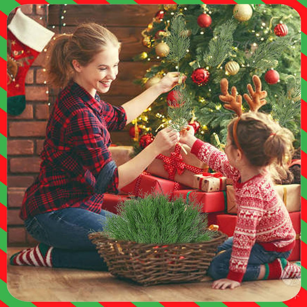 Mother and child decorating a Christmas tree with artificial pine branches from a basket.