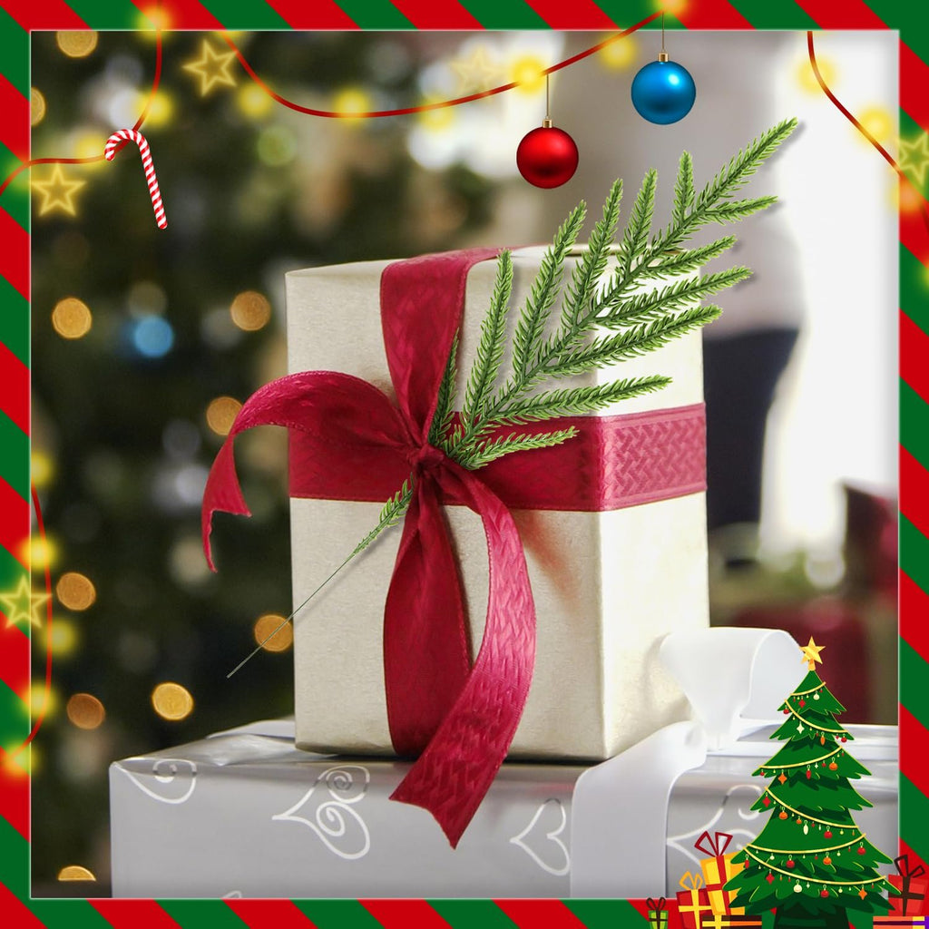 Christmas gift box with a pine sprig and red ribbon, surrounded by festive decorations and a blurred Christmas tree.