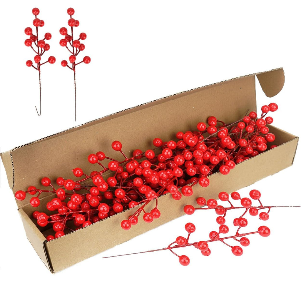 Artificial red berry stems in a cardboard box with two stems outside the box