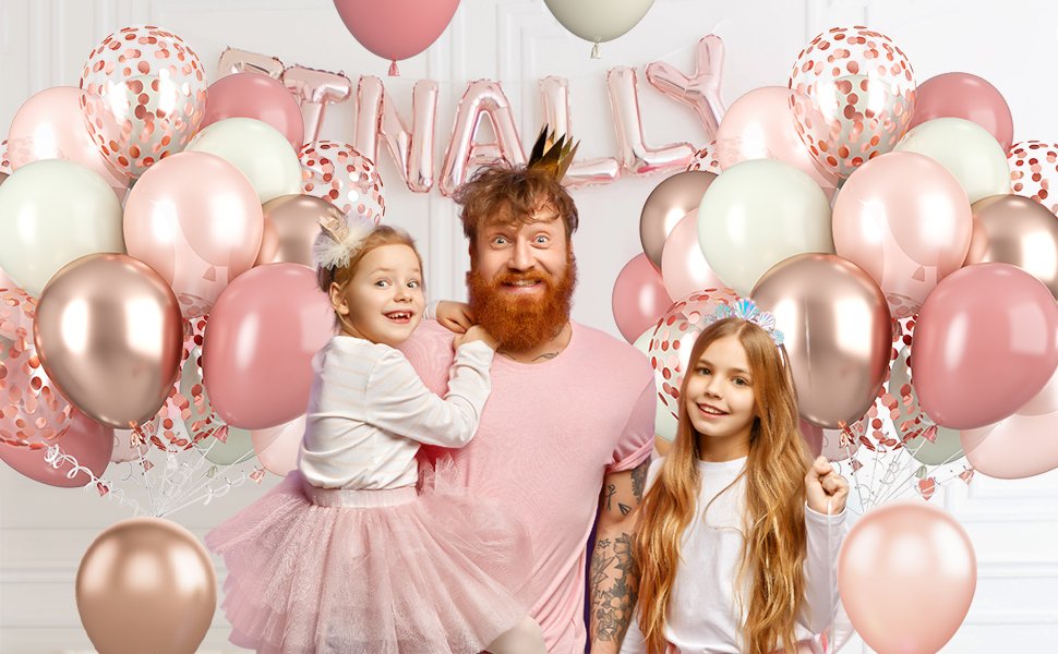 Family celebrating with dusty pink, rose gold, and confetti balloons, with 'FINALLY' foil balloons in background