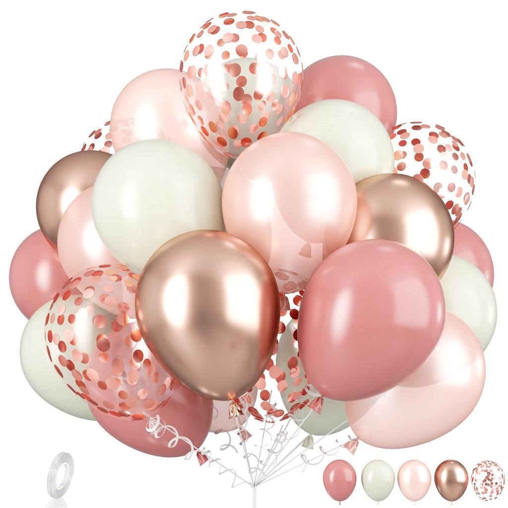 Dusty pink, rose gold, ivory, and confetti balloons arranged in a bouquet with a roll of white ribbon and a balloon stand.