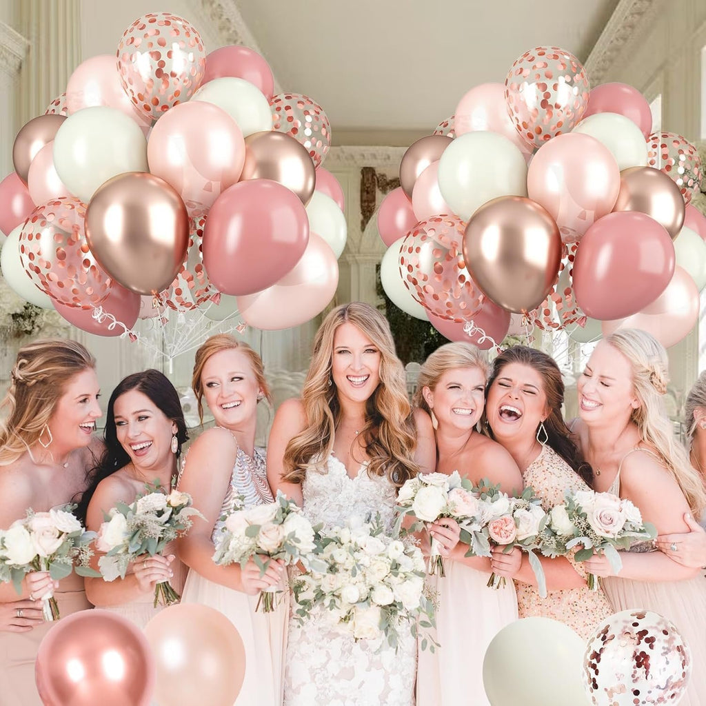 Wedding party with bouquets and dusty pink, rose gold, and ivory balloons.
