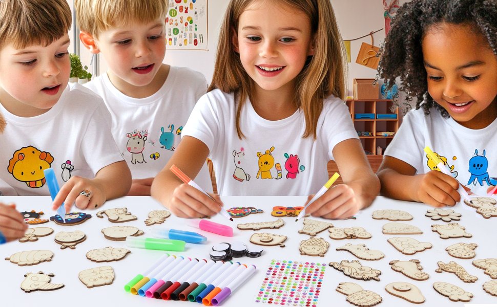 Four children painting wooden magnet cutouts on a table with markers and stickers