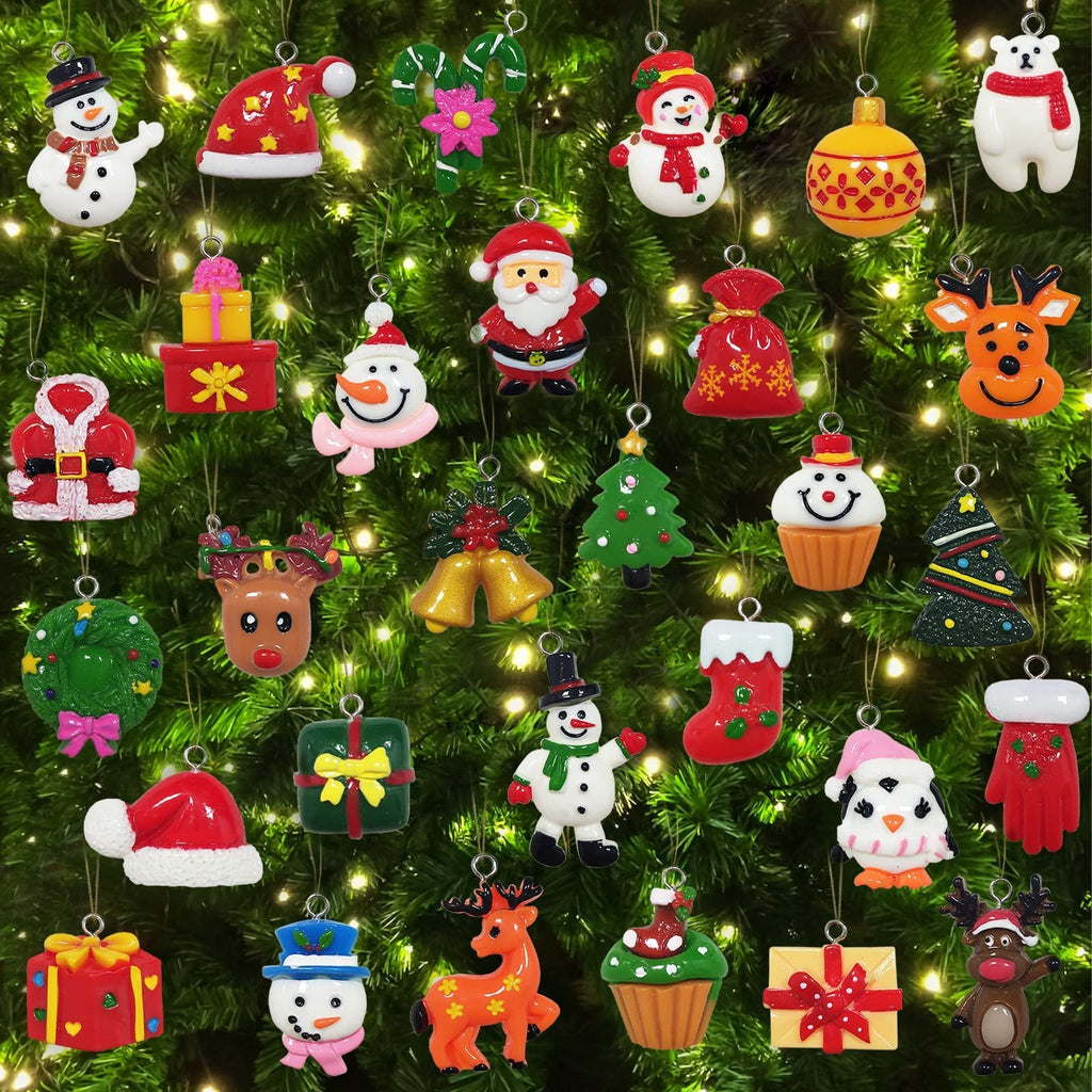 Collection of 30 assorted mini resin Christmas ornaments hanging on a decorated tree, featuring snowmen, Santa, reindeer, penguins, gifts, and stockings.