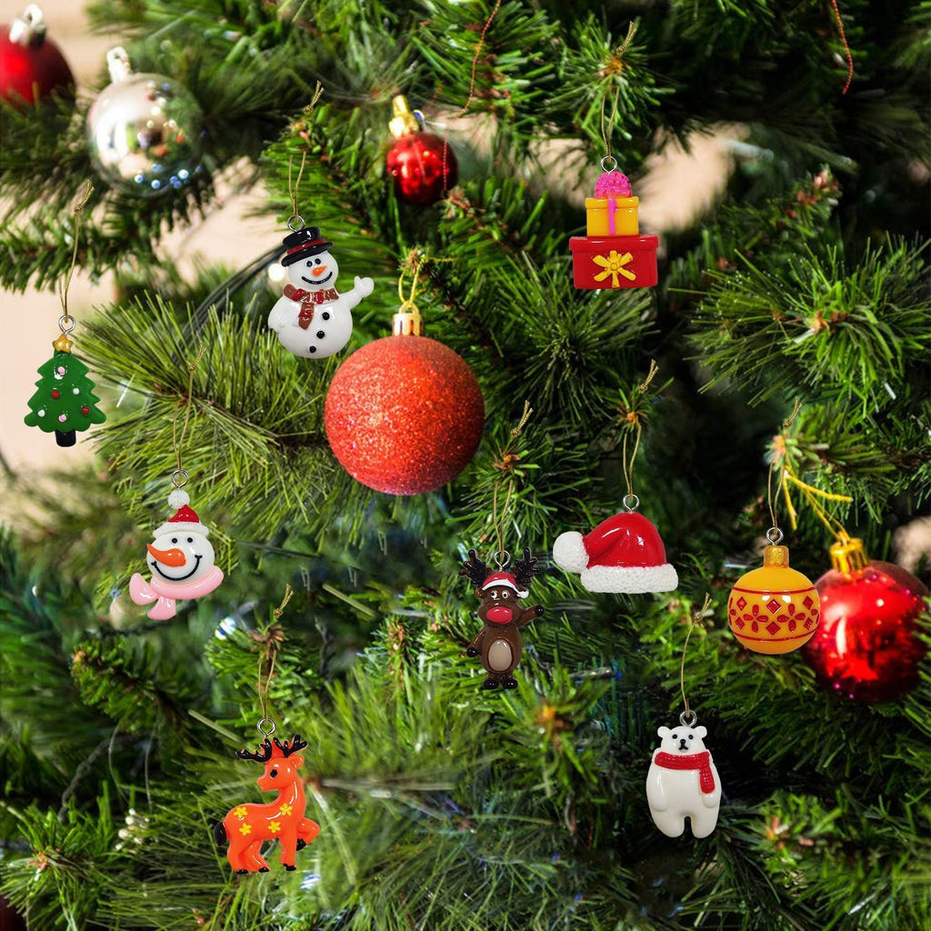 Assorted mini Christmas ornaments including snowmen, reindeer, polar bear, Santa hat, and gift boxes hanging on a decorated tree.