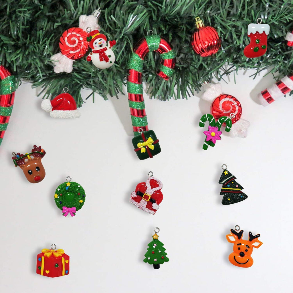 Assorted mini Christmas ornaments including Santa, snowman, reindeer, and trees arranged on a white surface with a garland.