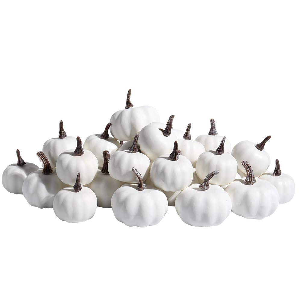 Pile of 30 assorted size white mini pumpkins with brown stems on a white background