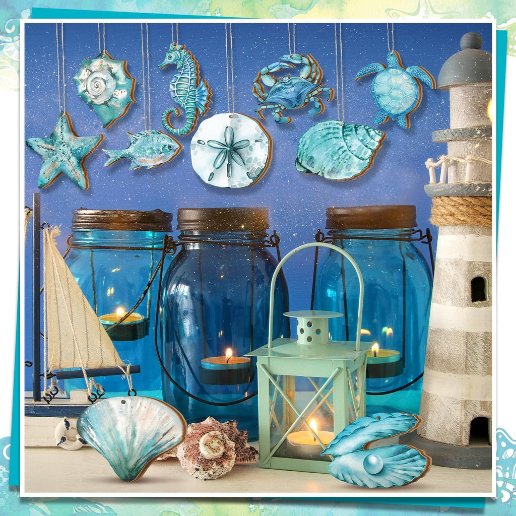 Ocean-themed wooden ornaments including a seahorse, crab, turtle, starfish, fish, sand dollar, and shells, displayed with blue jars, candles, a lantern, and a lighthouse.