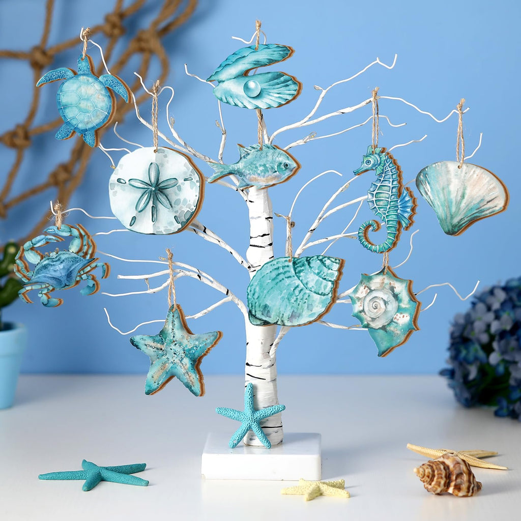 White tree display with 10 wooden ocean animal ornaments including a turtle, crab, starfish, sand dollar, fish, seahorse, and shells.