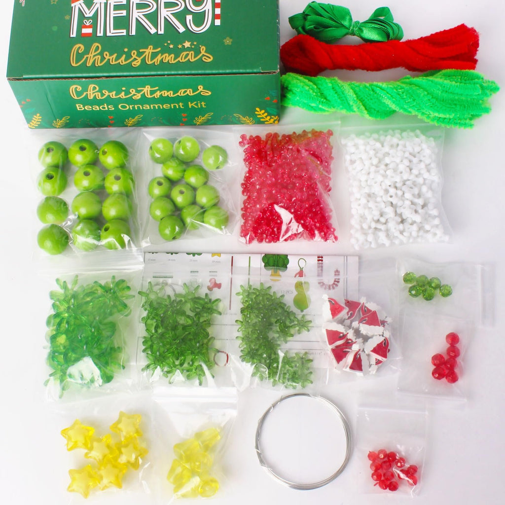 Christmas beads ornament kit contents including green and red beads, pipe cleaners, ribbon, and wire on a white background.