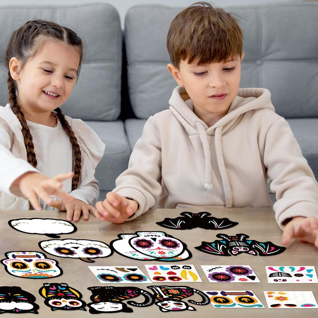 Two children crafting Day of the Dead sugar skull magnets on a table with colorful craft supplies spread out.