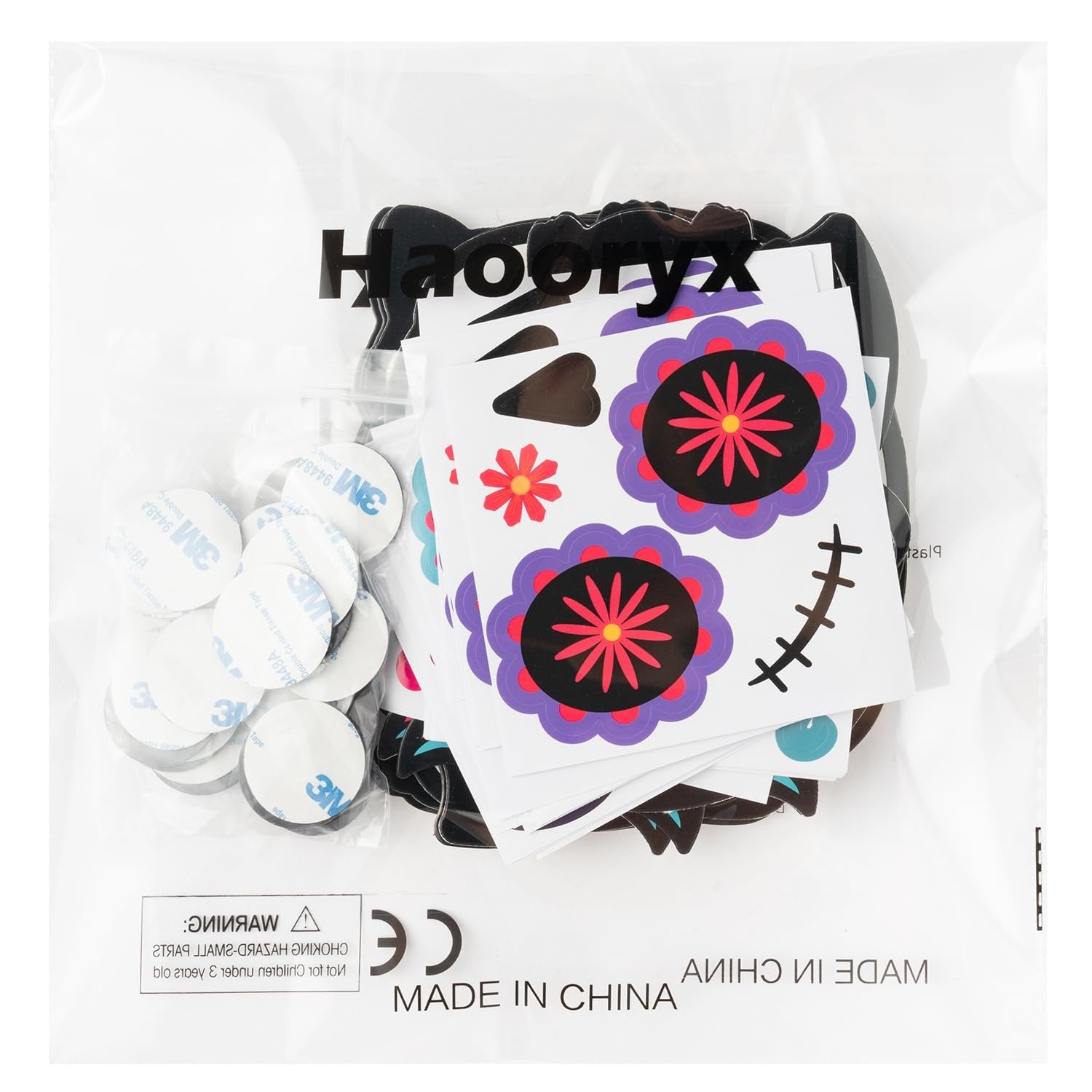 Day of the Dead magnet craft kit contents including stickers, foam shapes, and adhesive dots, inside a clear plastic bag.