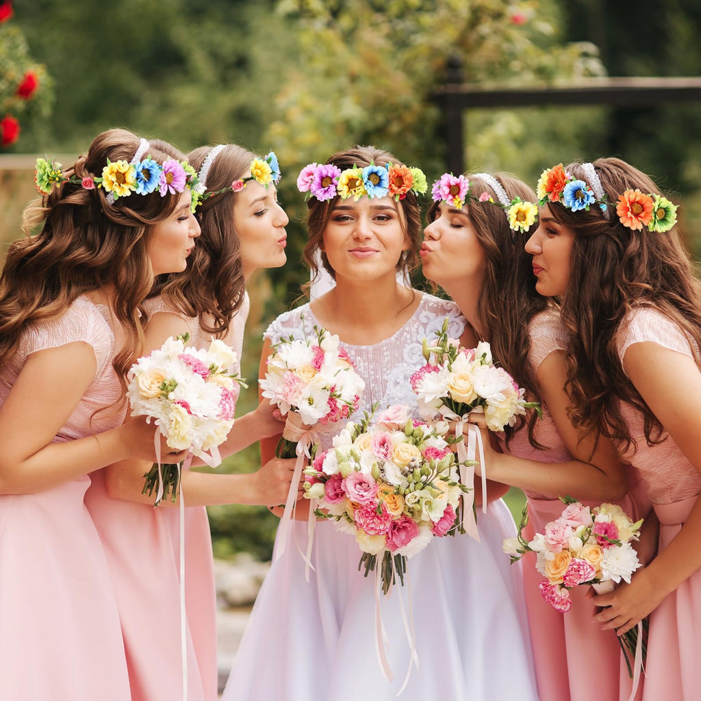 Bride and bridesmaids wearing flower crowns and holding bouquets, outdoors setting.