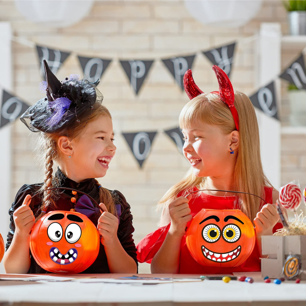 Two smiling girls in Halloween costumes holding pumpkin buckets, with a 'Happy Halloween' banner in the background.