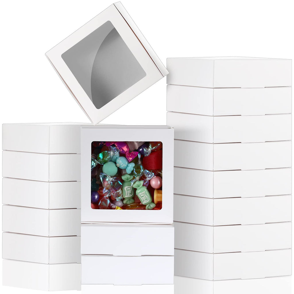 Stack of white paper boxes with clear windows, one box filled with colorful candies