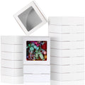 Stack of white paper boxes with clear windows, one box filled with colorful candies